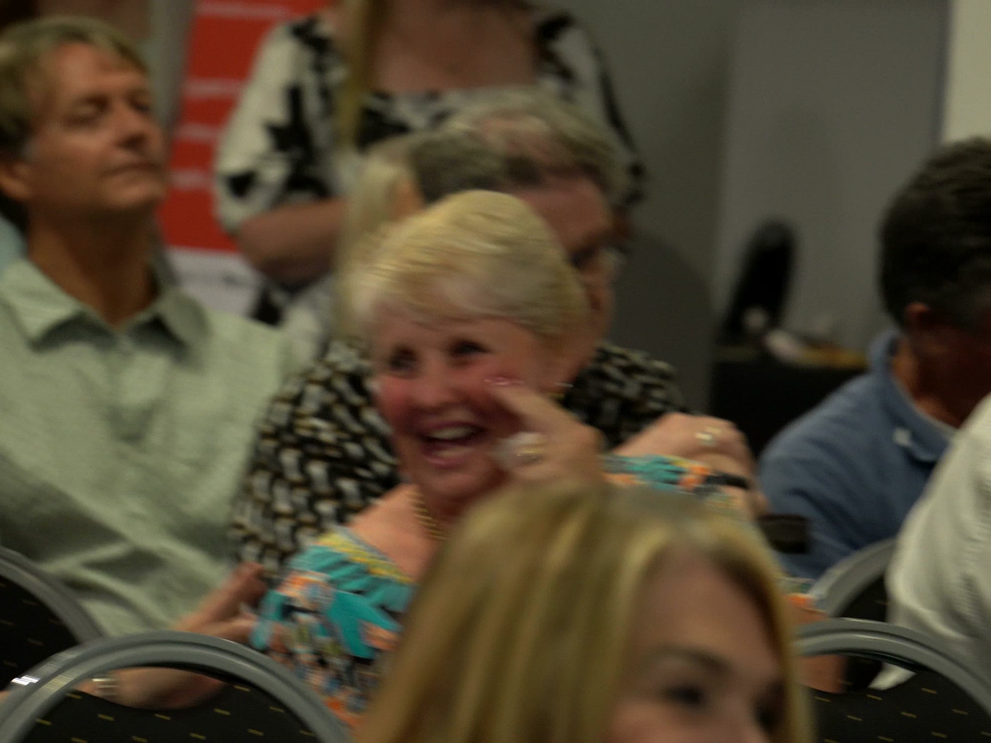 Guests laughing together in the audience during the evening programme.