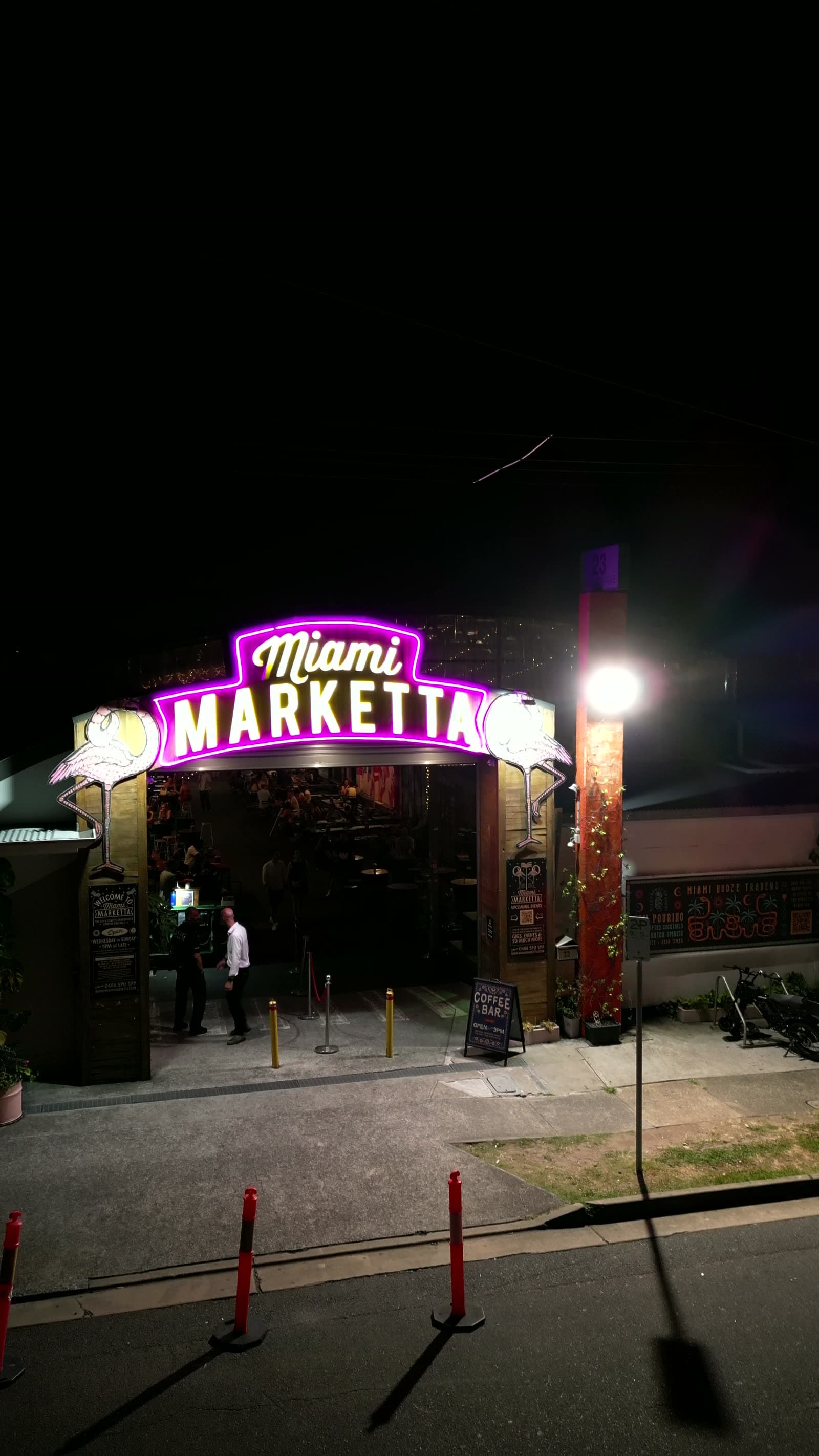 A guest walking in under the Miami Marketta archway on a spring evening.